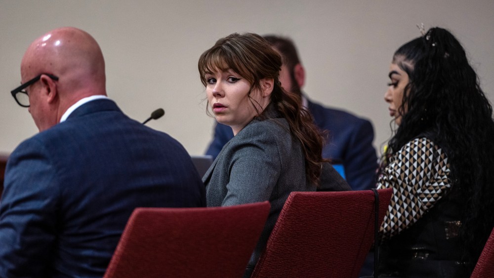Hannah Gutierrez-Reed, center, sits with her attorney Jason Bowles, left, during the first day of testimony in the trial against her in First District Court, in Santa Fe, N.M., Thursday, February 22, 2024. Gutierrez-Reed, who was working as the armorer on the movie